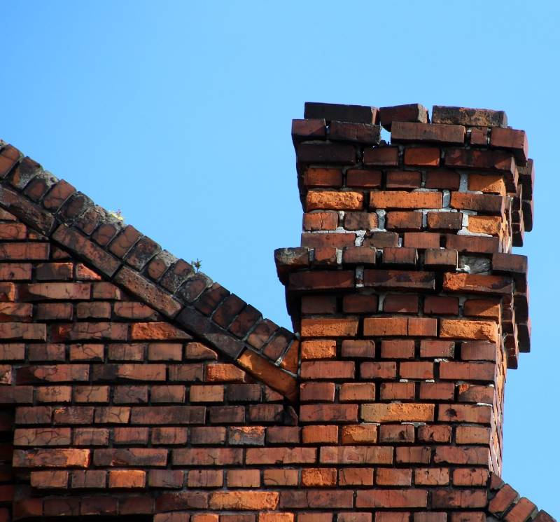 Signs Your Calverton Home Needs a Chimney Inspection Damaged chimney on an Calverton home showing cracks and missing mortar